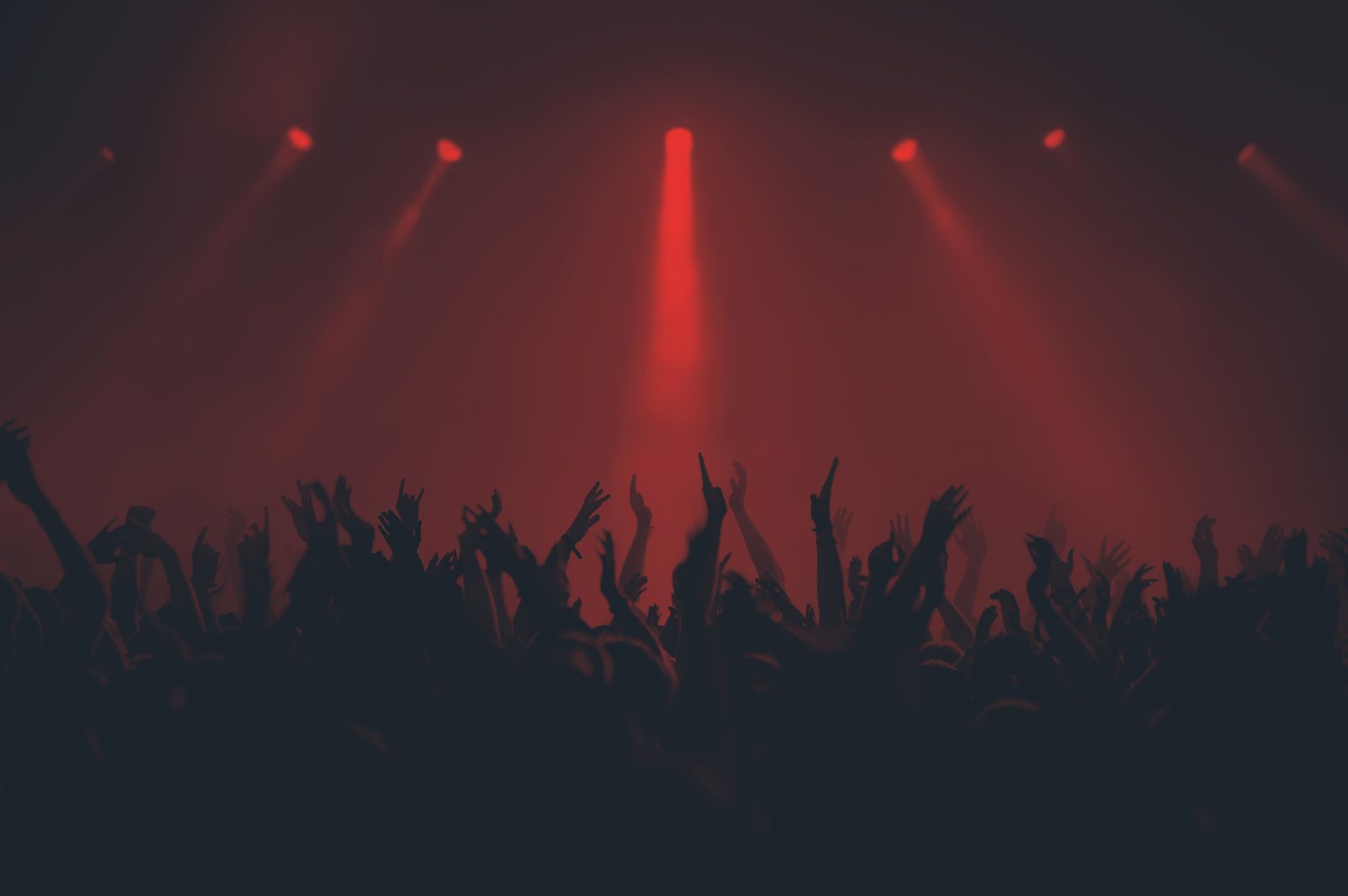 Crowd at a live event under red lights