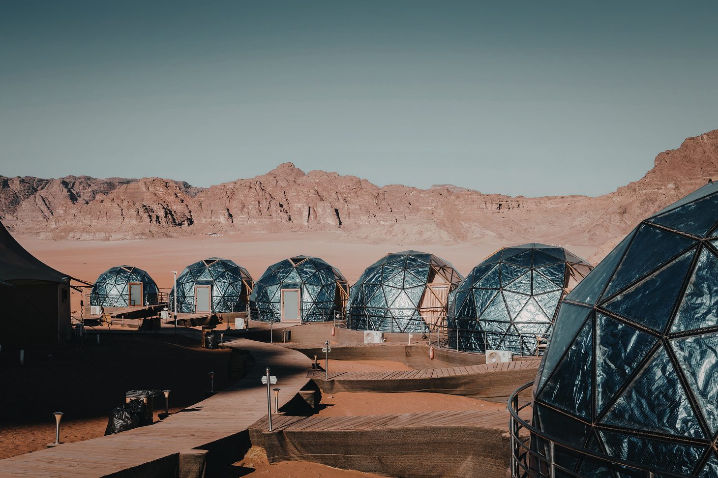 Geodesic glamping domes at sunset in the desert